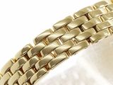 an image of a close up of a gold bracelet on a white surface