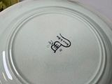 a white plate with a black and white logo on it