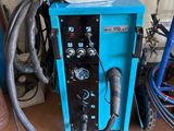 a blue machine that is sitting in a garage