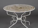 a white table with a circular top and a metal base