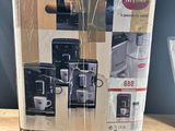 packaging of a coffee machine sitting on top of a wooden table