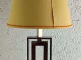 a lamp that is sitting on a table with a yellow shade