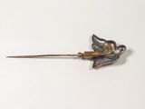a silver bird on a stick with a gold handle