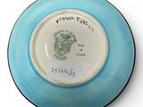 a blue and white plate with a picture of a lion on it