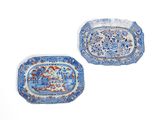 two blue and white plates with floral designs on them on a white surface