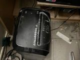 a black toaster sitting on the floor next to a toaster oven