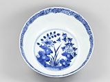 blue and white plate with blue flowers and leaves on it