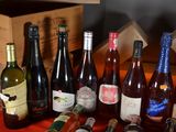 many bottles of wine sitting on a table next to each other