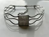 silver plated bracelet with a picture of a woman on it
