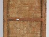 an old wooden box with a label on it sitting on a white surface