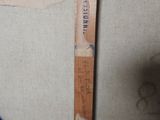 a wooden ruler that has a picture of a person on it