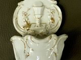 a white porcelain teapot with a bird on top of it