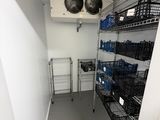 a room that has a bunch of baskets on the shelves