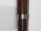 a close up of a wooden and metal object on a wall