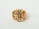 a close up of a gold ring with diamonds on a white background