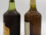 two bottles of wine sitting next to each other on a white surface