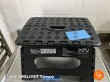a black plastic box with a blue tag on it