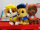 three stuffed animals that are sitting on a red tray