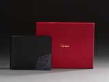 a black and red wallet sitting next to a red box