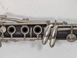 a close up of a clarinet that is laying on a table