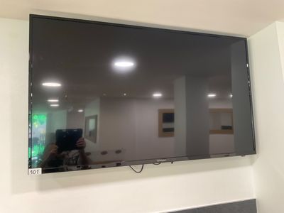 a flat screen tv hanging on the wall in the room