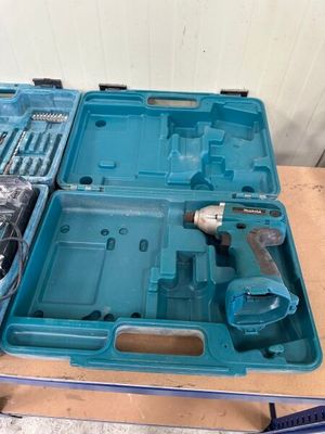 a blue tool box with tools in it on a table