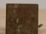a brown marble block sitting on a wooden table