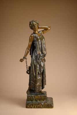 bronze statue of a woman holding a basket of flowers on a pedestal
