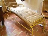a chaise lounger in the corner of a room