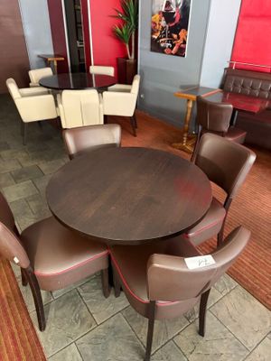 a table and chairs in a room with a red wall