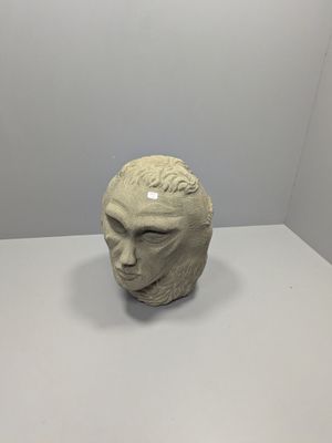 a sculpture of a man ' s head on a table