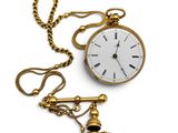 a gold pocket watch with a chain attached to it