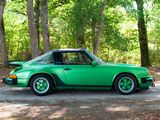 a green car that is parked on the side of the road