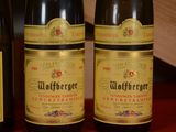 three bottles of wine are lined up on a table
