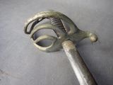 a metal object with a handle on a table