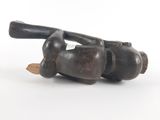 a small wooden object with a wooden handle on a white surface