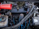 a close up of a car ' s engine with a red cap