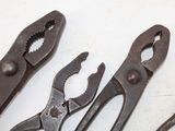 three pliers and a pair of pliers on a table