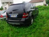 a black mercedes suv parked in a grassy field