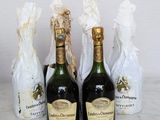 three bottles of champagne sitting next to each other on a table
