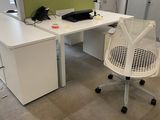 a desk with a chair and a phone on it