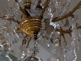 a chandelier that has a glass ball hanging from it