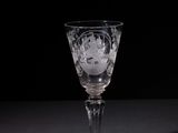 a wine glass that is sitting on a table