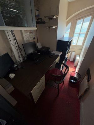 a view of a home office with a desk and a chair