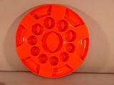 an orange plastic plate with holes in the middle of it