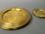 a gold plate and a silver plate sitting on a table
