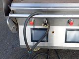 a gas grill with a hose attached to it