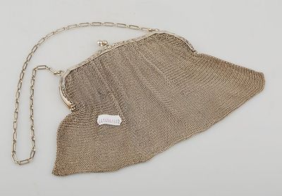 an antique silver mesh purse with a chain strap and clasp