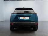 the rear end of a blue car in a white room
