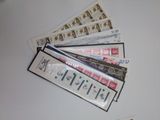 a lot of stamps on a table with a pen